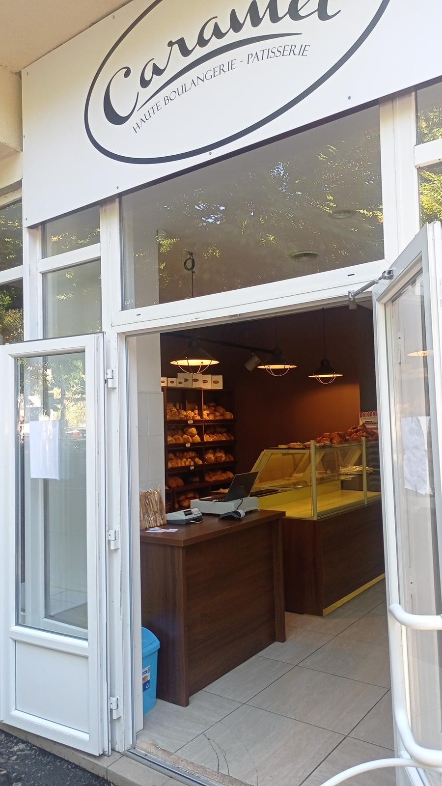 Intrarea în magazinul Caramel, cu ușa deschisă și sigla deasupra